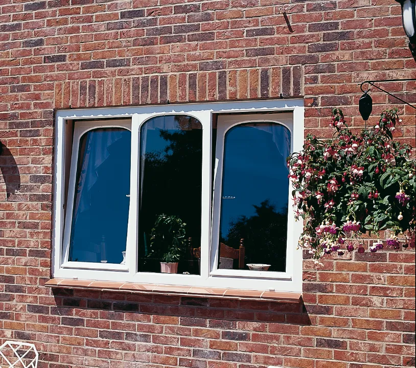 white coloured Tilt & Turn window installed at brick house
