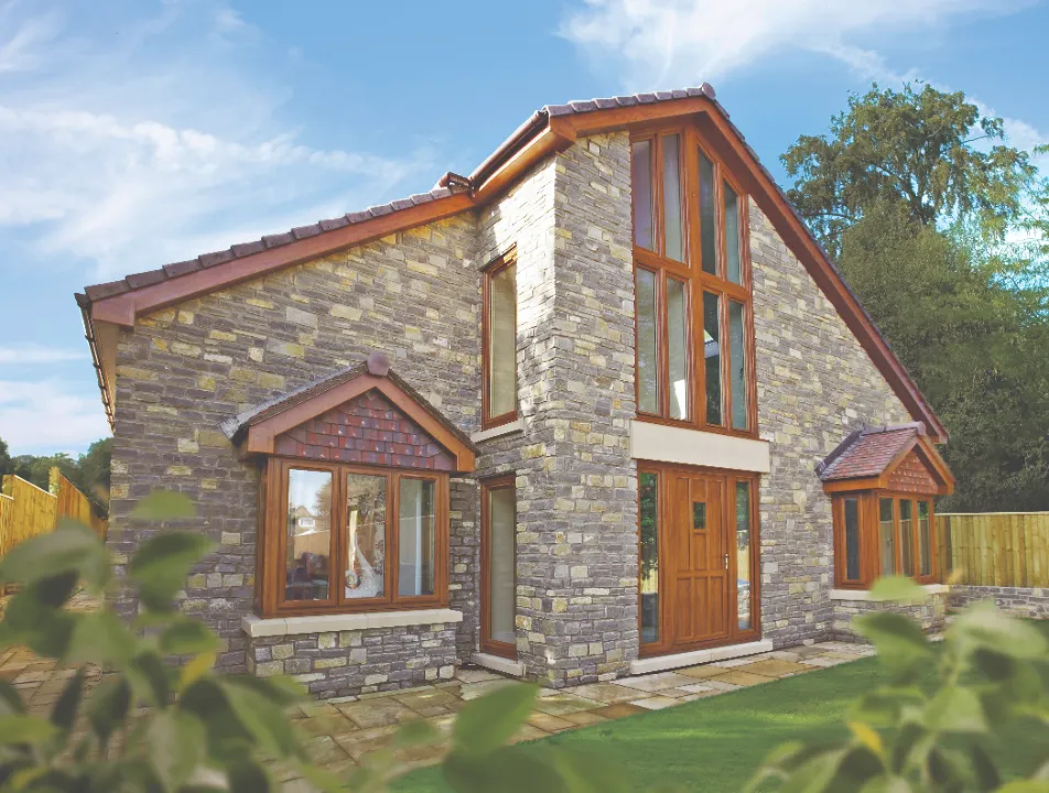 Timber windows and entrance door fitted to a stone-built detached home
