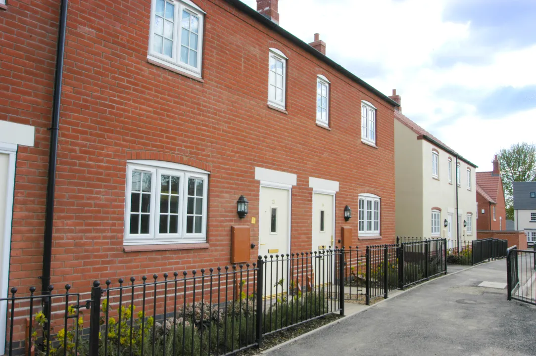 White windows and entrance doors fitted to modern red brick homes