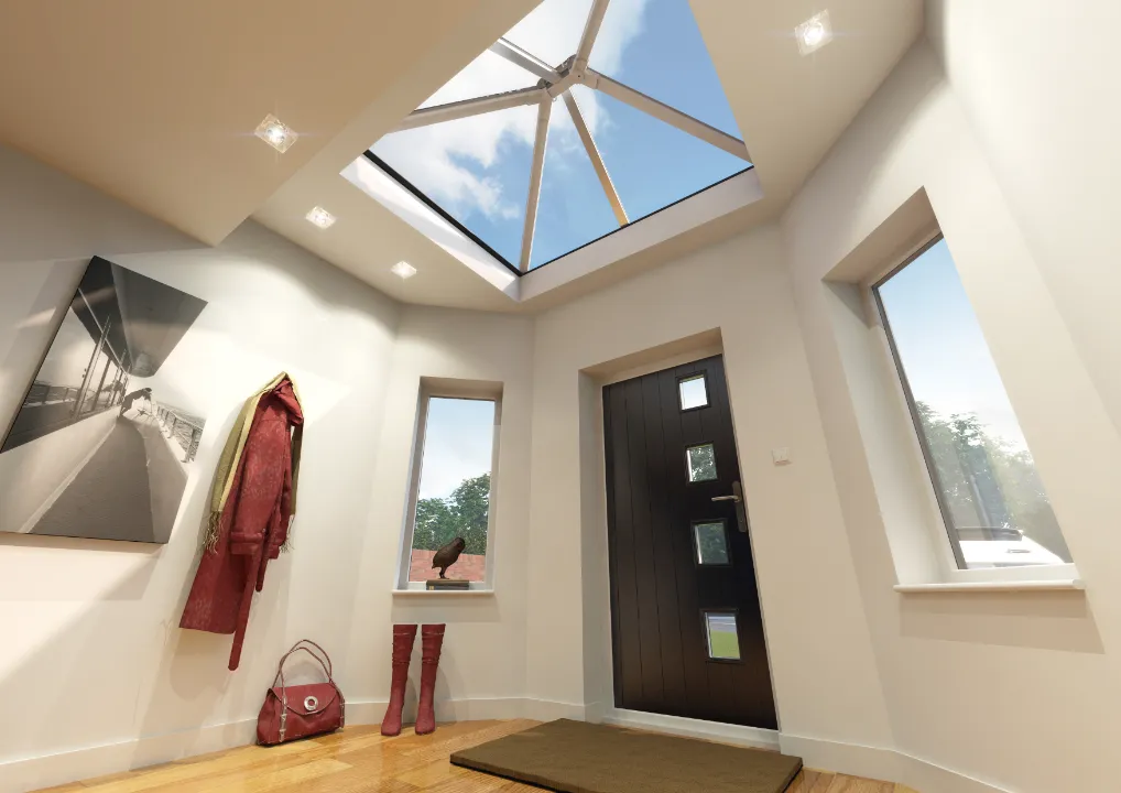 Interior entry foyer looking up at a square glass roof lantern integrated into a white ceiling above a dark front door and neutral decor.
